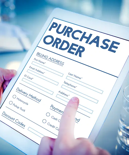 Close-up of professionals using a digital tablet to review vendor quotes and purchase details, illustrating improved vendor and purchase management through a purchase order management system.